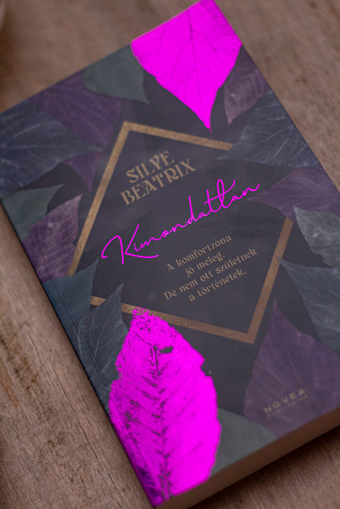 A Kimondatlan regény teljes körű könyvtervezése: szöveggondozás, profi tördelés és egyedi borítótervezés látványos lila-pink fóliaprégeléssel.